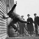 Man testing a prototype football helmet 1912